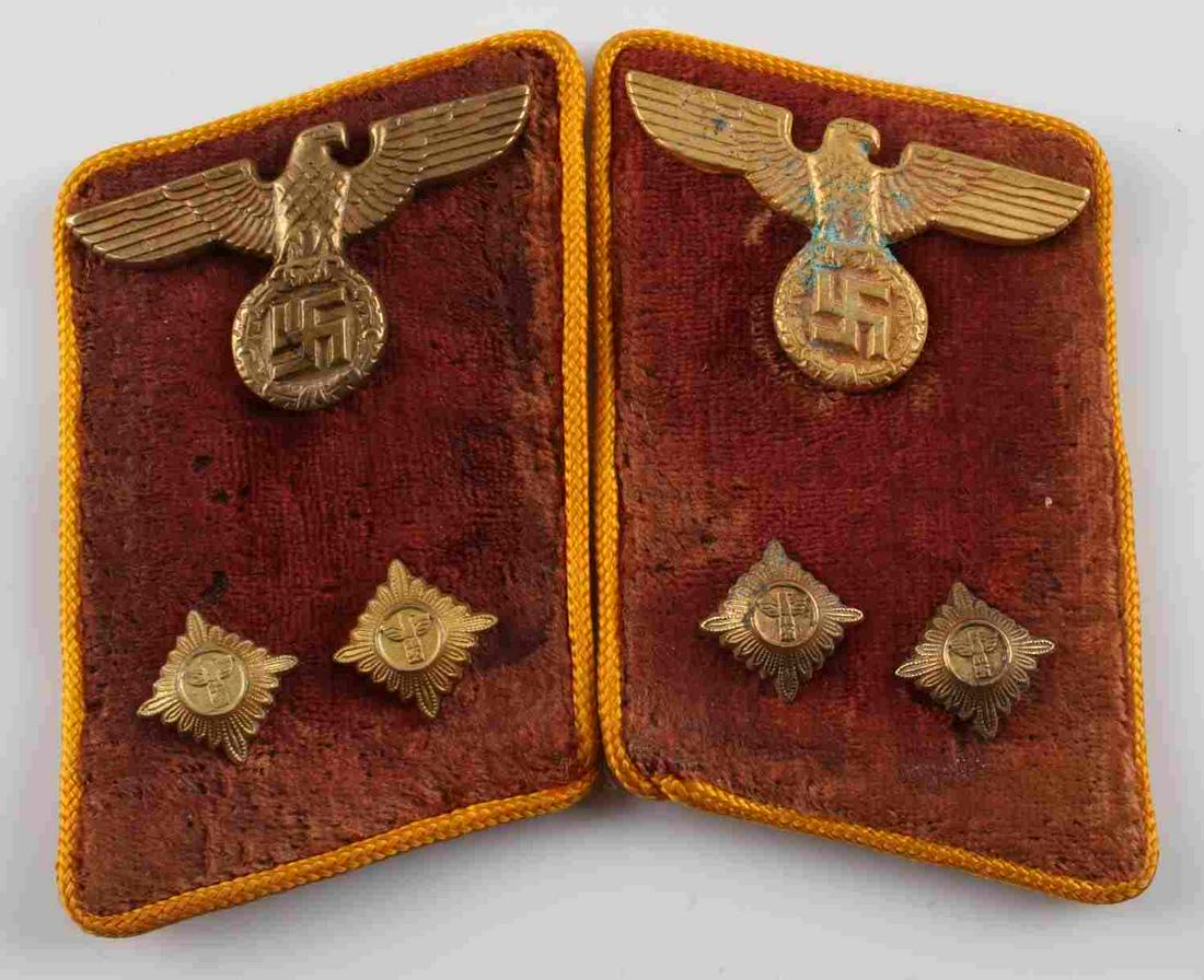 PAIR OF WWII GERMAN NSDAP OFFICERS COLLAR TABS: Pair of German WWII Political Leader Officers Collar Tabs. They measure 1 3/4 inches wide by 2 15/16 inches tall. The front shows an SS eagle clutching a swastika in his talons. Below are two brass pi