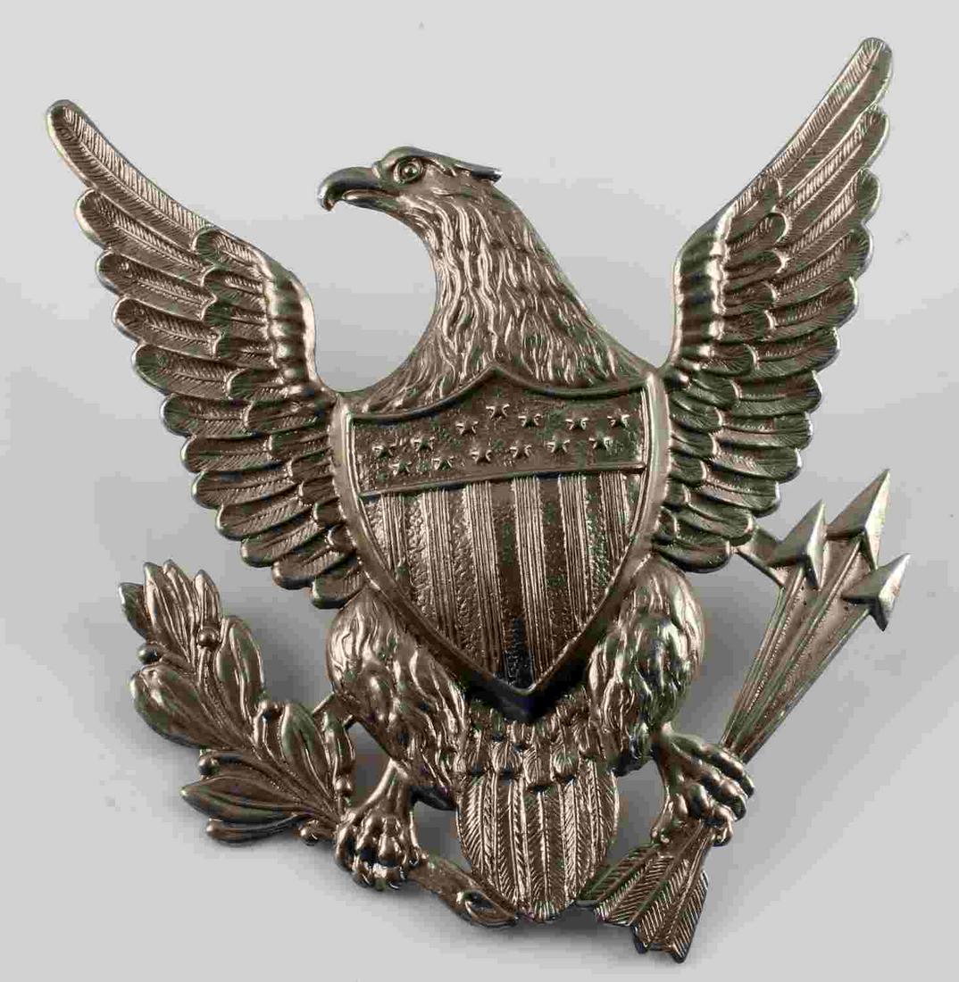 US INDIAN WARS MILITARY SPIKE HELMET FRONT EAGLE: US Indian Wars Army 1880’s Military Spike Helmet Eagle Front Plate. Measures 4 1/8” wide by 4 1/4” tall. The front shows a spread winged eagle with a shield in the center of his chest. He is clu
