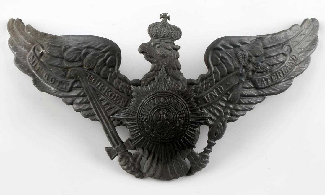 WWI PRUSSIAN GUARD EM SPIKE HELMET FRONT PLATE: Imperial German WWI Prussian Guard Regiment EM Spike Helmet Front Plate. Measures 7 5/8 inches wide by 4 1/4 inches tall. The front reads ‘Mit Gott fur Konig und Waterland’. There is a star burst 