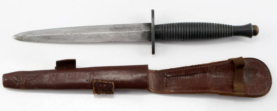 WWII BRITISH FAIRBAIRN COMMANDO FIGHTING KNIFE: British WWII Fairbairn Sykes Commando Combat Fighting Knife & Scabbard. The knife itself measures 10 7/8” long overall. The double edged steel blade measures 13/16” wide by 6 1/8” long. The ribb