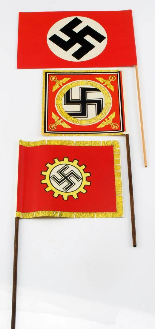 WWII GERMAN THIRD REICH NSDAP PAPER RALLY FLAGS: Three WWII German third reich NSDAP paper rally flags, all three mounted on wooden "poles". Swastika standarte flag measures at 5 inches by 5 inches. Deutches Arbeitsfront flag measures at 5 3/4 inche