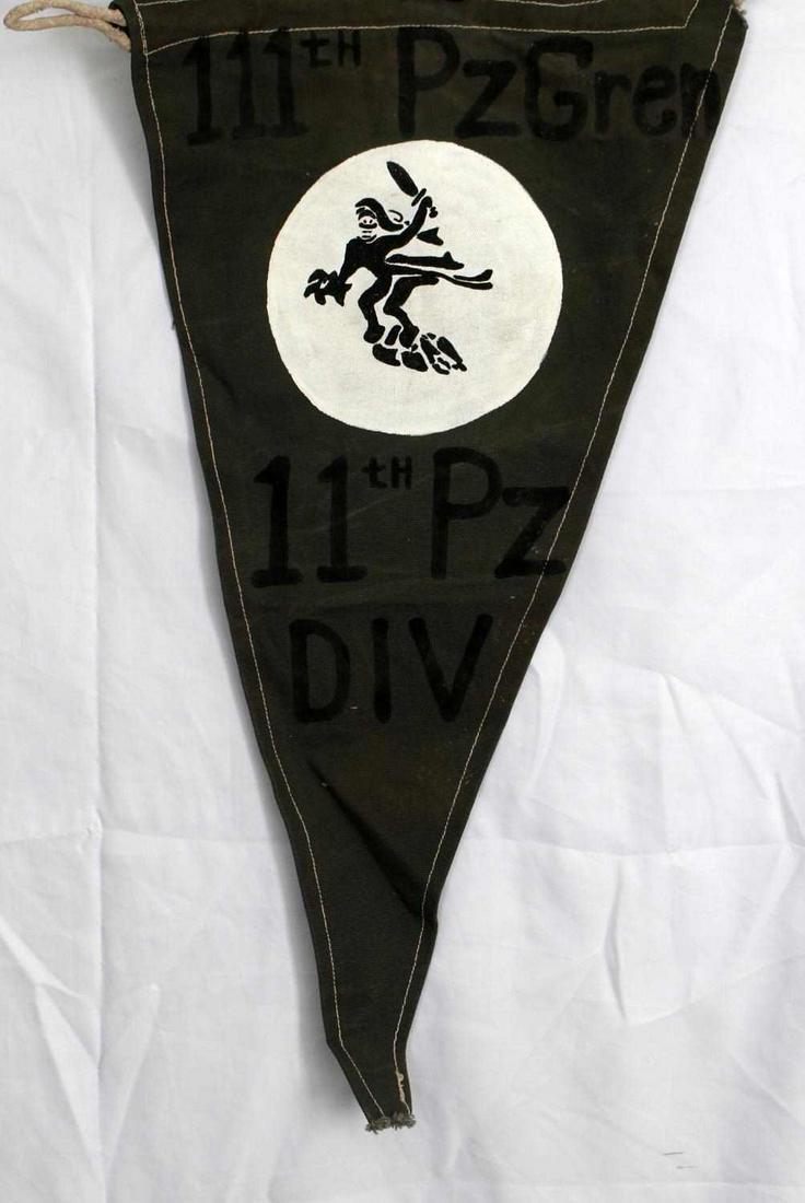 WWII GERMAN 3RD REICH 11TH PANZER DIVISION PENNANT: German WWII Army 111 th Panzer Grenadier 11 th PZ Division Pennant. Measures 12 1/2" wide by 22 1/4" tall. The front reads ‘111 th Pz Gren 11 th Pz Div’. Has a soldier holding a knife in the cente
