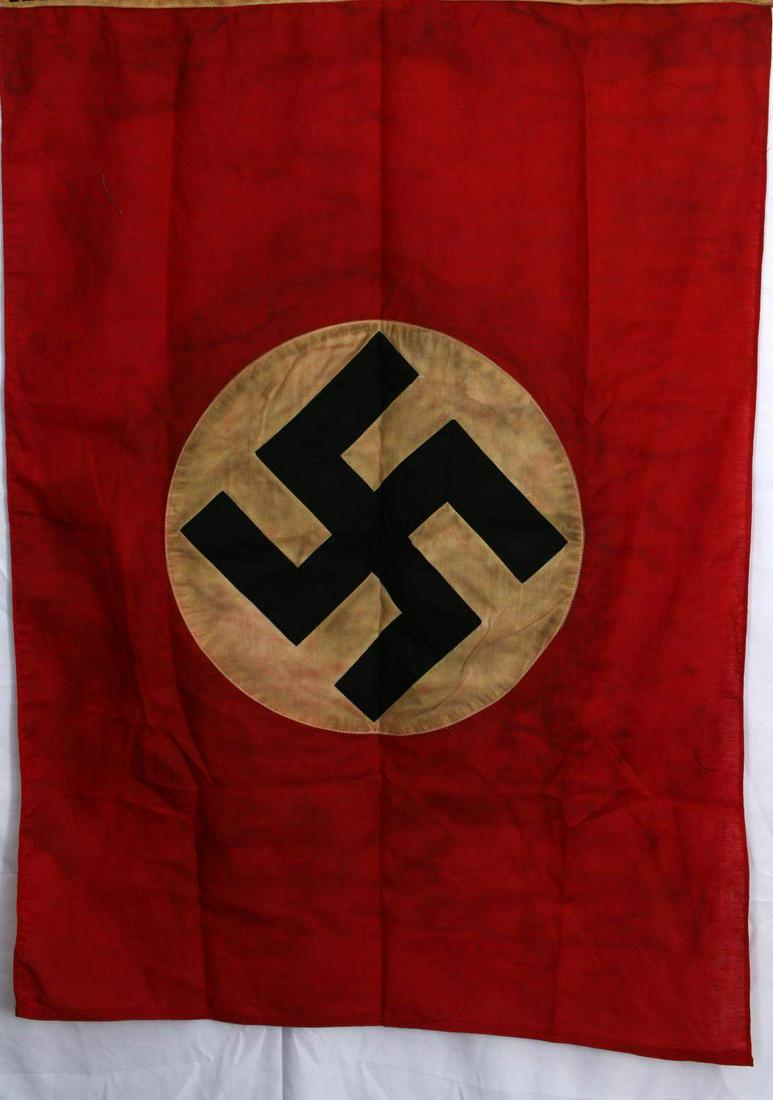 WWII GERMAN THIRD REICH NSDAP SWASTIKA BANNER: German WWII NSDAP Political Swastika Banner Flag. Measures 34 1/2” wide by 24 3/4” tall. The front shows a swastika in a diamond in the center of a red background with two white stripes tall. The 