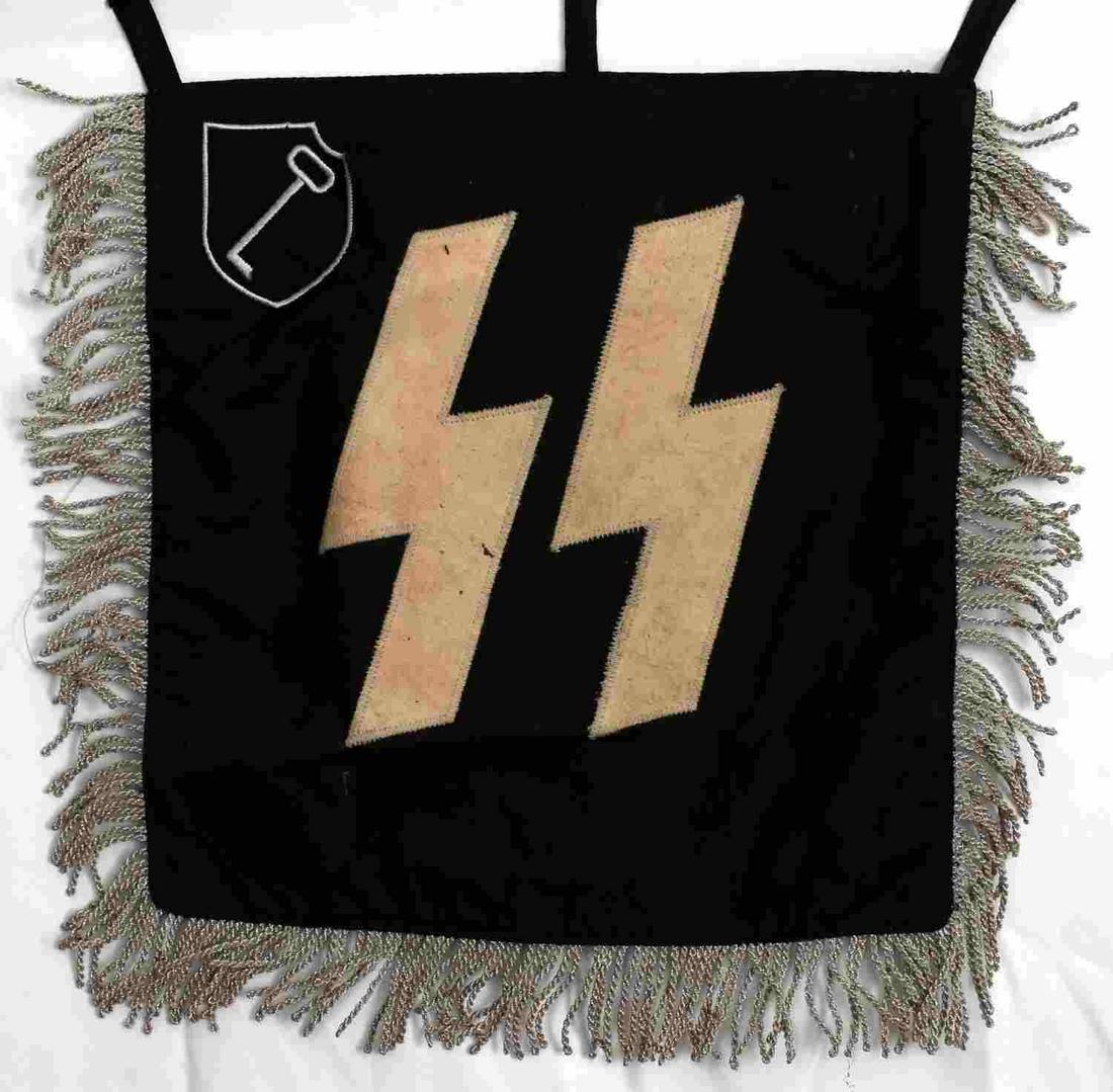 166285GERMAN WWII WAFFEN SS 27TH TOTENKOPF BANNER: Measures 14 1/4" wide by 13 1/4" tall including the fringe. Shows a pair of Waffen SS runics on one side with a Totenkopf skull and cross bones on the other side. There are machine embroidered Waffen