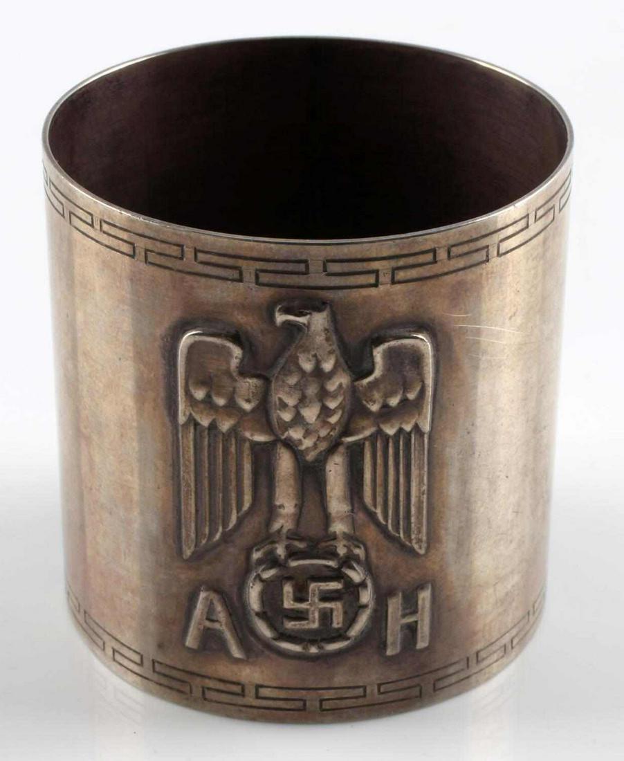 ADOLF HITLER FORMAL PATTERN NAPKIN RING 935 SILVER: German World War II Dictator Adolf Hitler AH Formal Silver Napkin Ring. Measures 1 3/4 inches tall by 1 11/16 inches in diameter. The front shows a raised political eagle clutching a swastika in his t