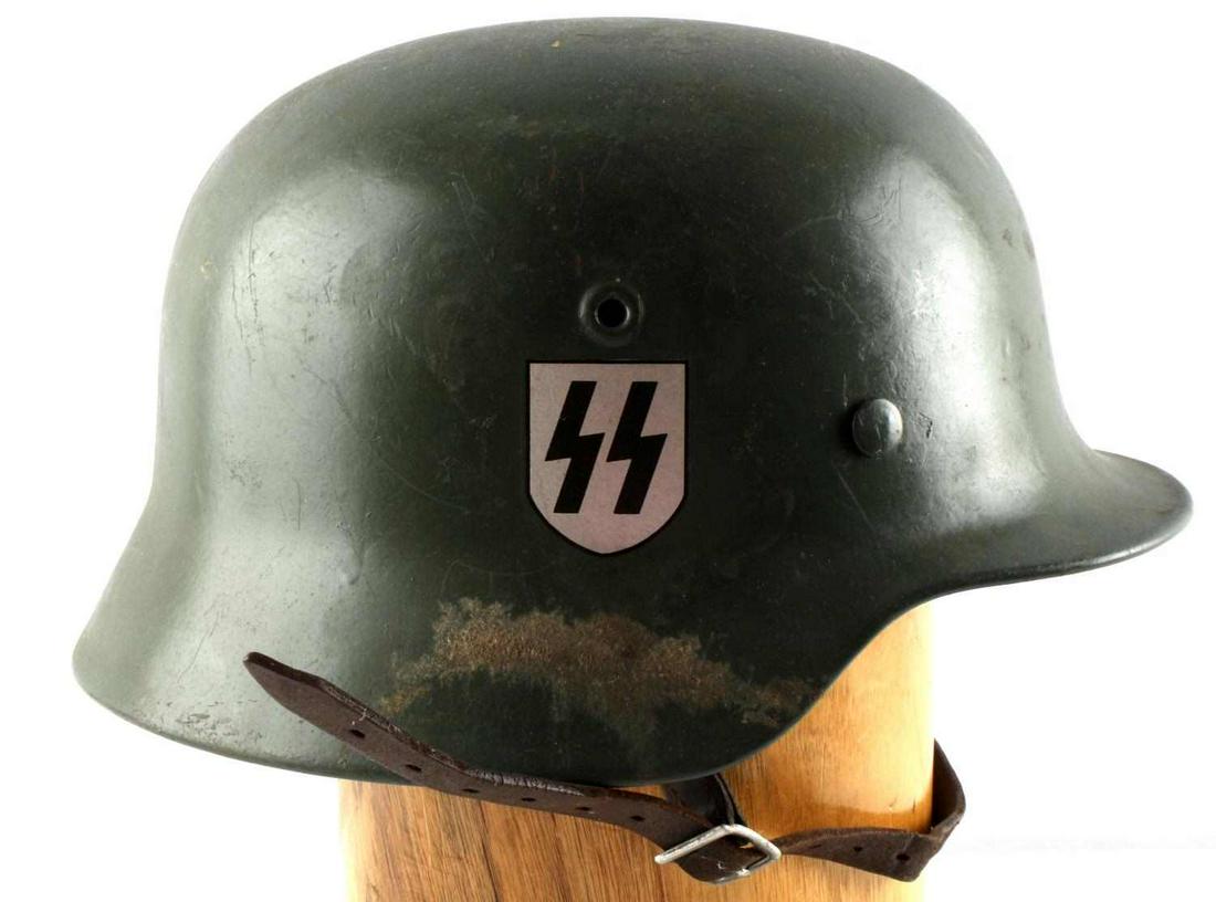 WWII THIRD REICH GERMAN WAFFEN SS HELMET W LINER: Painted green helmet with SS decal to right ear and swastika shield decal to left ear, 8-finger leather liner marked 56 and Matr. Grone, leather chinstrap is a bit brittle, ET64 stamped to inner left 
