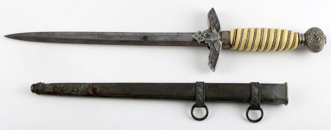 GERMAN WWII THIRD REICH LUFTWAFFE DAGGER 2ND MODEL: German World War II Luftwaffe 2nd model dagger, blade marked with F. W HOLLER SOLINGEN, has light scratching and oxidation. Pebble scabbard in very good conditon aside from light oxidation, has oak le