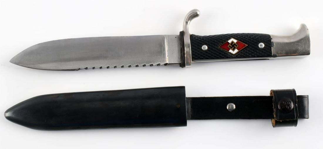 WWII HITLER YOUTH HJ CUSTOMIZED SAWBACK KNIFE: Weapon measures (24.5 cm) from tip of blade to end of hilt. The hilt itself measures (9.7 cm) while the blade measures (13 cm) . Blade is in relatively good condition with a custom serrated edge on th