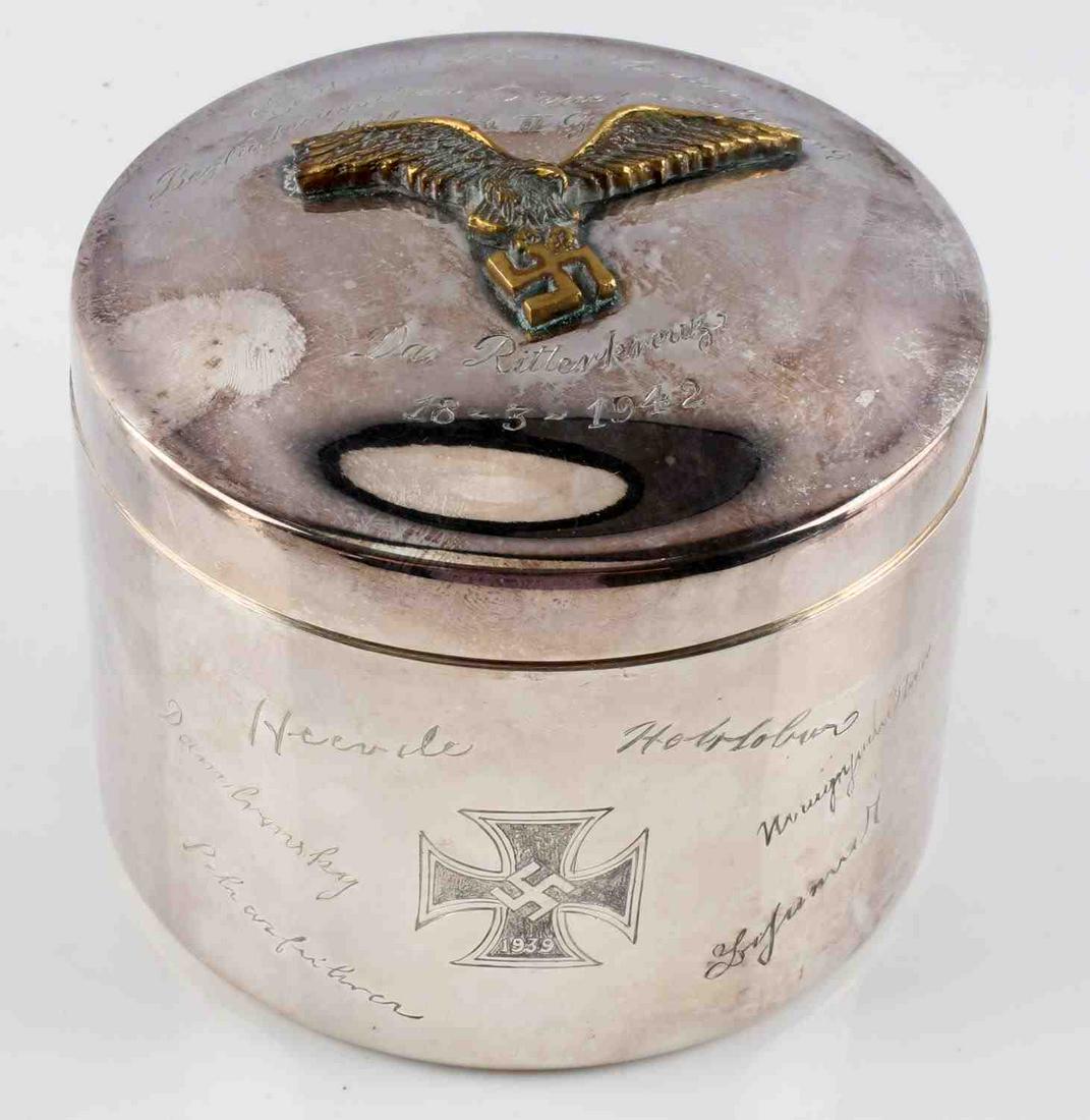 WWII GERMAN KNIGHTS CROSS PRESENTATION TOBACCO TIN: Name, title, and date etched to top of lid with gold tone Reichsadler in relief affixed. Stands 3 3/8 inches tall and 4.5 inches wide. Joh. Wagner & Sohn maker mark at bottom. Made from silver plate.