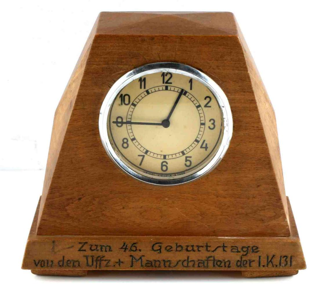 WWII GERMAN CLOCK INSIDE WOODEN TABLE STAND: This lot contains an interesting item. This is a military German clock that would have been put inside of a wooden table stand. The inscription in German reads, "On the 49th birthday from Officers and