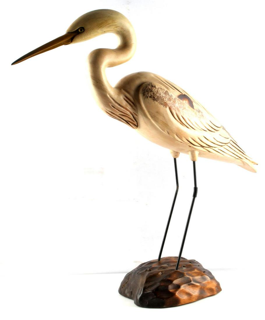TOM TABER HERON CARVED WOOD SCULPTURE: Tom Taber signed and carved wood Heron sculpture. It stands 27x26x7 inches. It has loss metal spring knee accent and wood around point of intersection to one leg.
