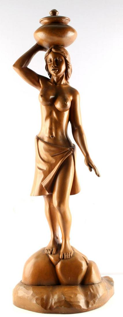 HAND CARVED WOOD STATUTE OF NUDE WOMAN W HEAD POT: Hand carved polished wooden statue of a nude woman with a pot on her head. The base is detachable from the statue. Some cracks along skirt and armpit are visible. Good condition. Stands 36 inches.
