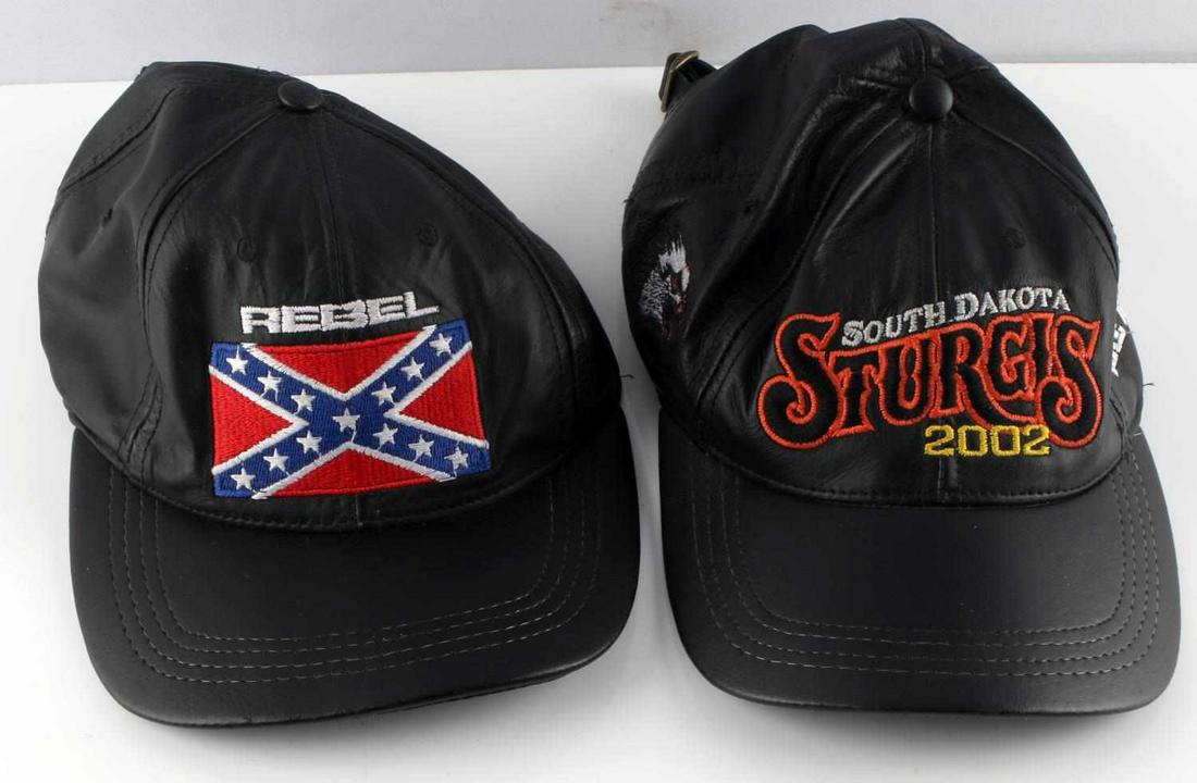 TWO BLACK LEATHER BIKER CAP LOT 1 SIZE FITS ALL: Lot includes one hat with a confederate flag embroidered on front, with the word "REBEL" above it. Sturgis Bike Week leather cap, one size fits all. Embroidered with "STURGIS SOUTH DAKOTA 2002" Good c