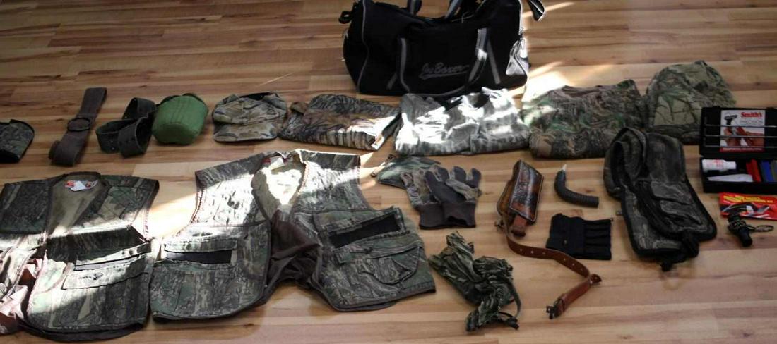 MENS HUNTING CLOTHING AND ACCESORIES: Lightly used cammoflage clothing and hunting accessories includes: medium vest, large vest, Smith's Precision knife sharpening kit, camo netted face mask, plastic rain proof hunting trousers (large), 