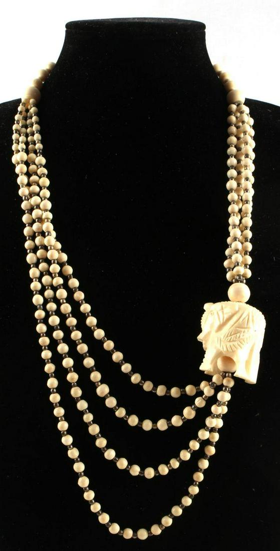ANTIQUE AFRICAN ELEPHANT EFFIGY BONE NECKLACE: Three-strand asymmetrical bone beaded necklace with elephant on one side. Measures 15.5 inches long. Very good condition.