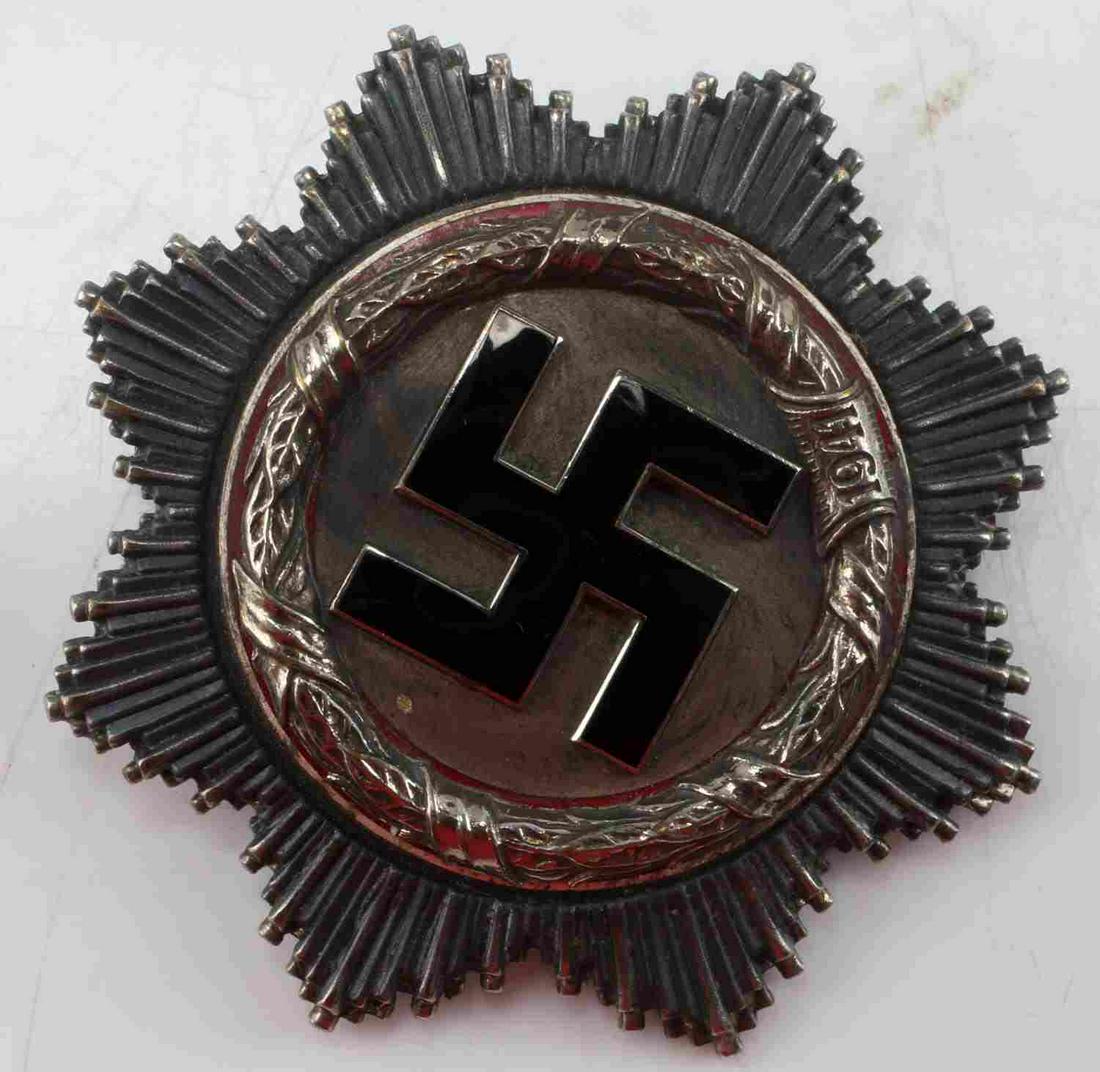 WWII THIRD REICH GERMAN CROSS IN SILVER: WWII Third Reich German Cross in silver. Badge measures 2.5 inches across. Dated with year "1941" inscribed on front. Badge is stamped with makers mark "20" on back pi. Features vertical style pinback
