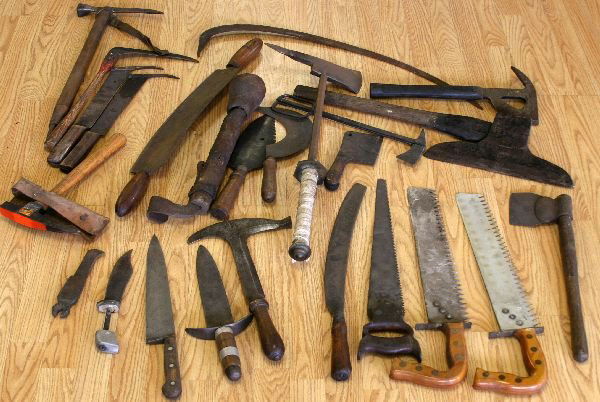 ANTIQUE TOOL LOT - SAW AXE CUTTERS SCRAPPERS: Vintage tool lot; 5 axes of different types; 3 saws; a corn cutter, scrappers, knives, and other tools, in a Lawrence Bros wood crate. Together with a vintage ice axe.