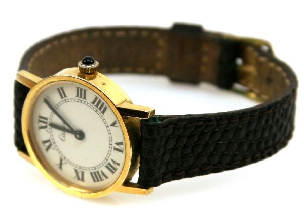 LADIES CARTIER WATCH: Cartier round dial watch, 24mm round 20 micron plated case, cream colored roman numeral dial. Seventeen jewel manual movement, Signed on case and movement. Replacement bracelet. Service required.