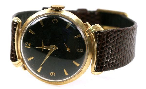 MENS 14K GOLD LONGINES WATCH: Vintage Men's Longines watch. 14k yellow gold case with genuine leather bracelet. Acrylic crystal. 17 jewel mechanical movement. Black face with Longines logo, second hand above 6 hour maker. Watch in