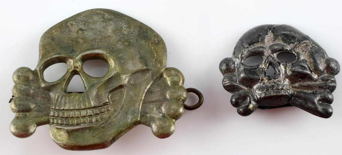 2 WWII GERMAN THIRD REICH SS VISOR DEATH HEAD LOT: Oversized Totenkopf 2 by 1 1/2 inches, east west lugg reverse with pin, 1 1/3 inch silver twin prong reverse, very good original condition.