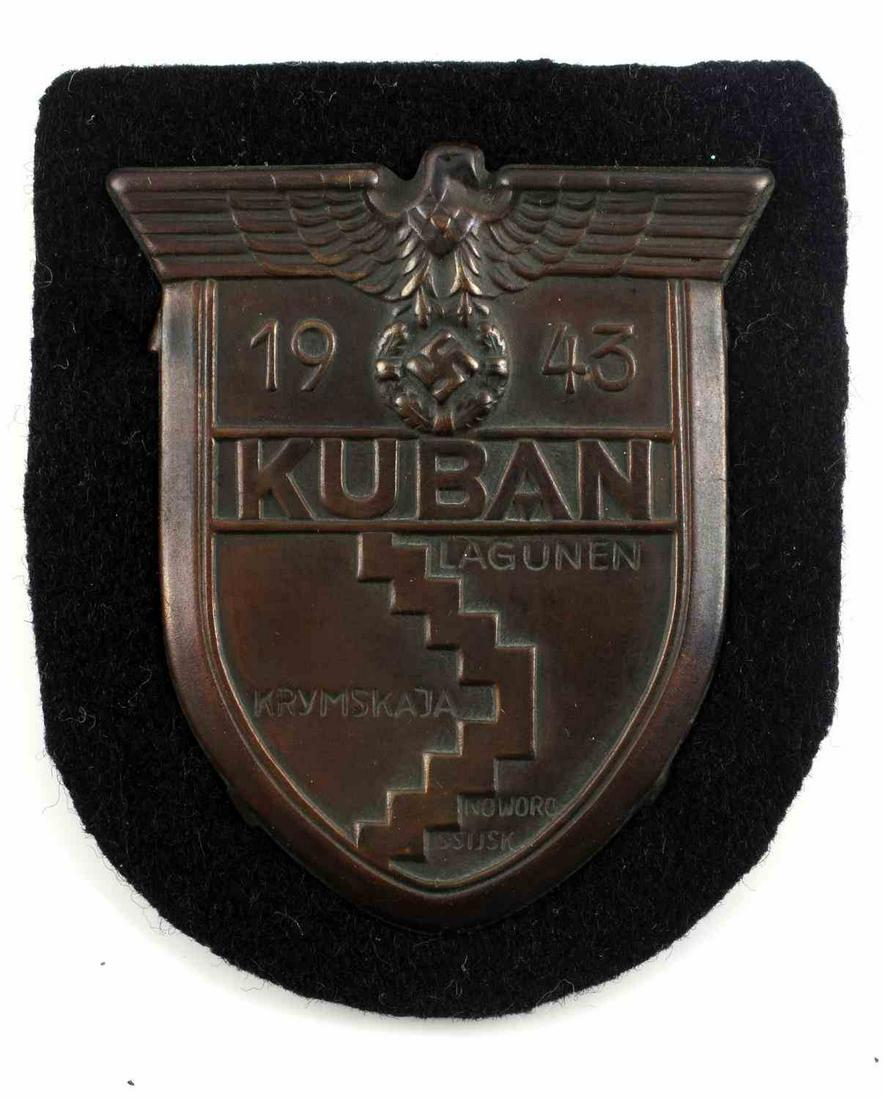 WWII GERMAN THIRD REICH KUBAN SHIELD PANZER CLOTH: WWII German Kuban Shield with paper backing on black Panzer cloth. The Kuban Shield (German: Ärmelschild Kuban) was a WWII military decoration of Nazi Germany, awarded to those who fought at the Kuba