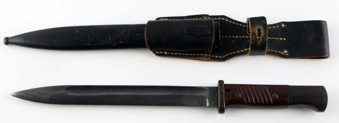 WWII GERMAN K98 BAYONET W FROG & SCABBARD: Near excellent blade, with very good Bakelite grips, blade dates 1944 and frog is dated 1943 and is near excellent condition, very good near full paint ans dent free scabbard