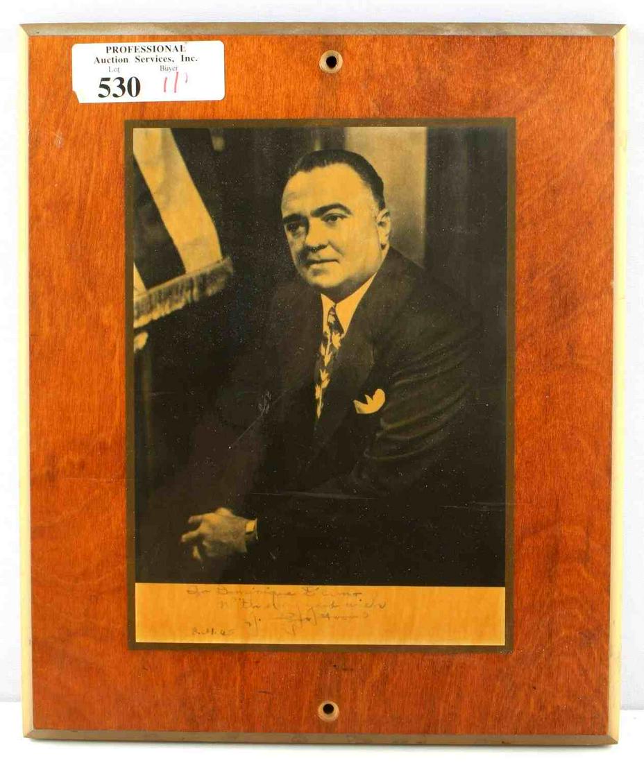 J EDGAR HOOVER AUTOGRAPH PHOTO TO DOMINIQUE D ERMO: Photo professionally mounted to plaque, given to restaurateur Dominique D'ermo, from J. Edgar Hoover. Dated 8/31/65. Inscription and autograph are a bit faded but still present and readable. Good cond