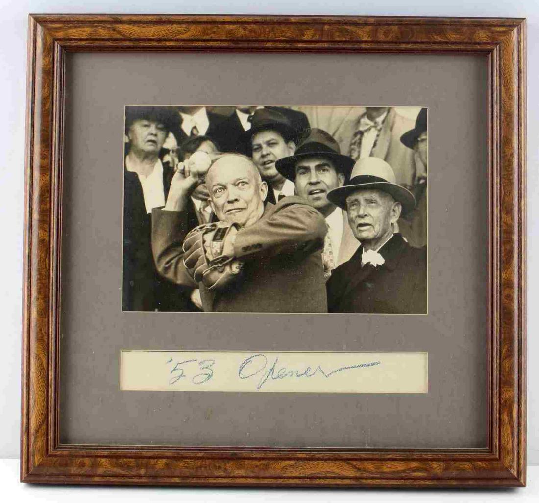 EISENHOWER BASEBALL OPENING DAY SIGNED PHOTOGRAPH: From opening day 1953, Dwight Eisenhower is photographed with Richard Nixon behind him throwing out the Opening Day Pitch in 1953. It appears that the clipping ('53 Opener) below the photograph is Eis