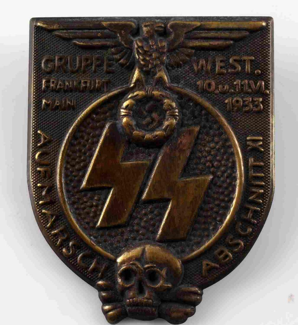GERMAN WWII WAFFEN SS 1933 FRANKFURT GRUPPE BADGE: Measures 1 3/8” wide by 1 3/4” tall. The front shows a German eagle clutching a swastika in his talons at the top. There is a pair of Waffen SS runics in the center and a skull and cross bones at