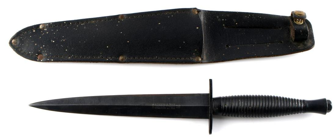 WWII BRITISH FAIRBAIRN SYKES KNIFE W SCABBARD: One black WWII British Fairbairn-Sykes commando fighting knife with scabbard. Marked "J. Nowill & Sons Sheffield, England C.O. Established A.D. 1700". Knife in good condition with some wear visible on