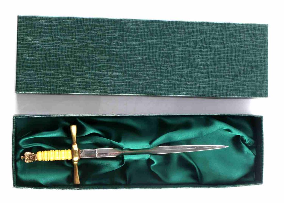 WWII THIRD REICH MINI KRIEGMARINE DAGGER SWORD: Miniature replica of a Kriegsmarine Dagger. Measures 8 in and the blade is 5 3/4 in. The blade shows some scratches. Includes green box with green fabric inside.