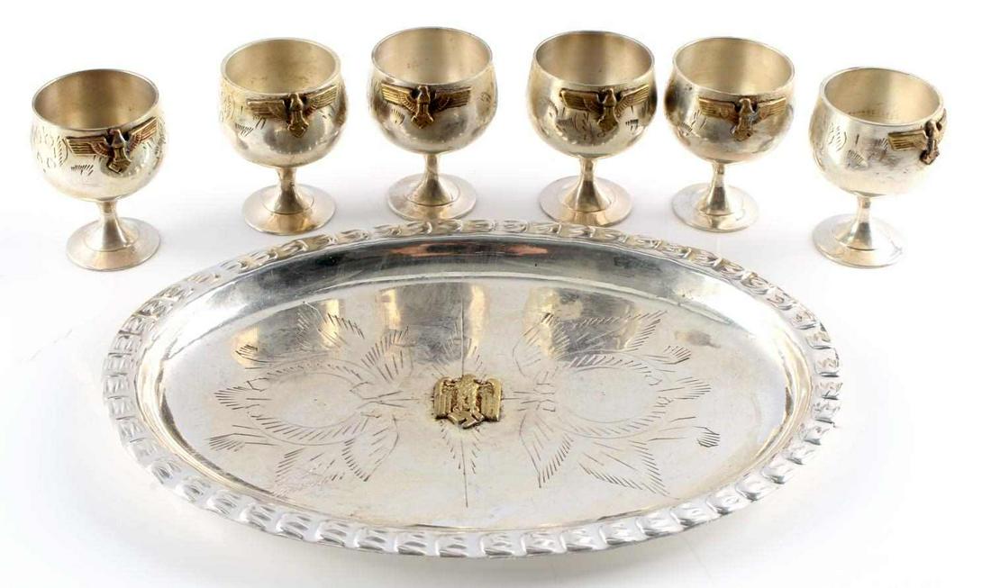 6 WWII GERMAN OFFICERS SCHNAPPS CUPS WITH TRAY: Set of six (6) WWII German Officer's schnapps cups with serving tray from the NSDAP Canteen. Cups measure 2 inches tall with a diameter of 1.5 inches (at mouth). Cups feature imperial eagle with swast