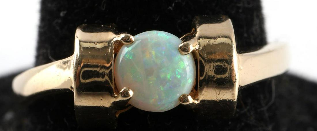 14KT GOLD AND OPAL SOLITAIRE CABOCHON RING: Hallmarked and acid tested as 14kt gold with a 5mm cabochon opal. Size 8 1/4, total weight 2.4 grams.