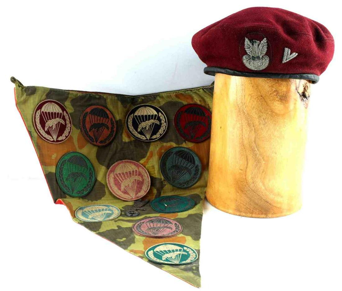 POLISH PARATROOPER BERET AND PATCHES LOT OF 11: Lot includes 11 patches that are glued onto a 19 1/2 X 14 1/2 pennant, and one maroon beret with Polish eagle insignia (size 57), very good condition and non-fluorescing.