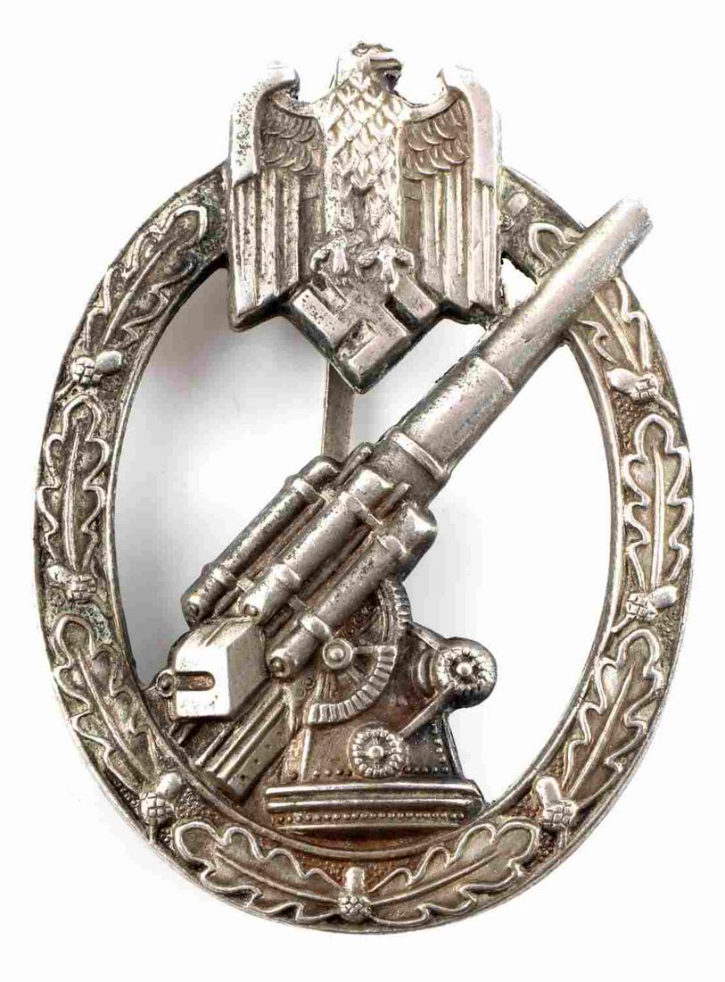 WWII THIRD REICH GERMAN ARTILLERY FLAK BADGE: Hollow back construction with tapered rear broad pin, 180 degree pin lie with squared "C" catch. In very good condition with some surface wear. Unauthenticated, sold as is.