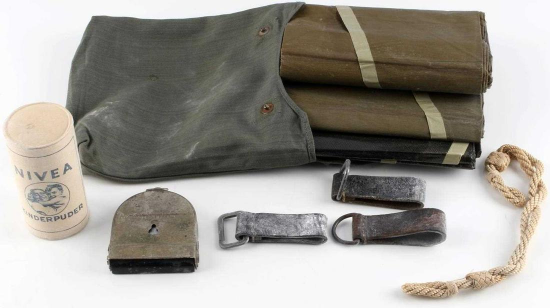 ASSORTED WWII THIRD REICH FIELD GEAR LOT OF 8: Lot of 8 includes one Nivea Kinderpuder, one Third Reich compass marked "Bezard-Kompass", three belt rings, one visor/gas mask chin cord, and one field bag with tarp.