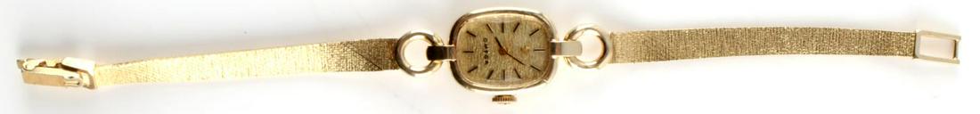 LADIES VINTAGE OMEGA SOLID 14KT GOLD WRISTWATCH: Dial reads Omega with symbol at top and gold batons as numerals. Soft rectangular case with open circle at top and bottom, attaching to soft gold bracelet. Marked 14K gold on case rear and clasp. Seri