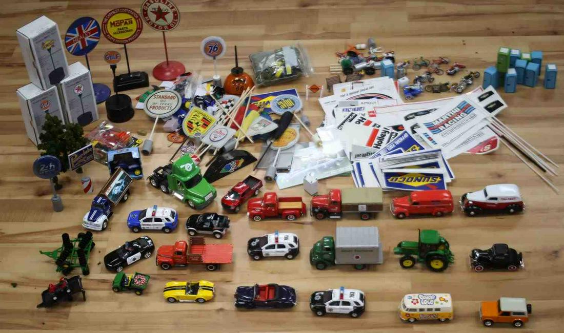LOT OF 23 ASSORTED MODEL CARS & BACKGROUND SCENERY: Lot of 23 assorted model cars to include motorcycles, pickup trucks, semi trucks, police cars, delivery trucks, 4X4's, a tractor, & other vehicles. Lot also includes background scenery for models such
