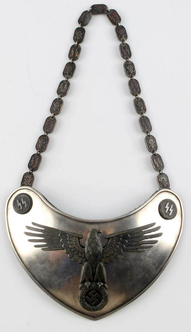 WWII GERMAN THIRD REICH SS GORGET 2ND TYPE: SS Gorget 2nd type with large SS Eagle on the front of the breast plate and SS runes in the corner bosses. Marked "RZM M1/128". Has forest green cloth backing that has loosened from age. This lot has