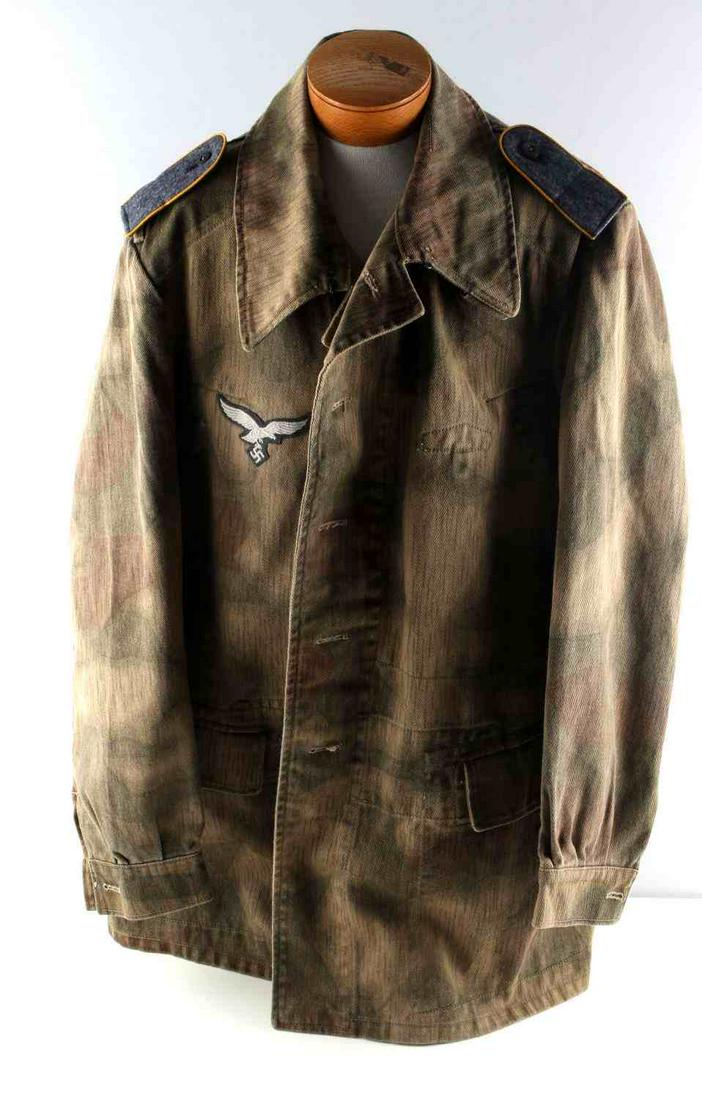 WWII GERMAN LUFTWAFFE COMBAT BUTTON UP SMOCK: WWII German Luftwaffe ground combat camo button up smock. Mint, unissued leftover supply depot piece. Has late war breast eagle and shoulder straps piped in yellow for a paratrooper. Inside has variou