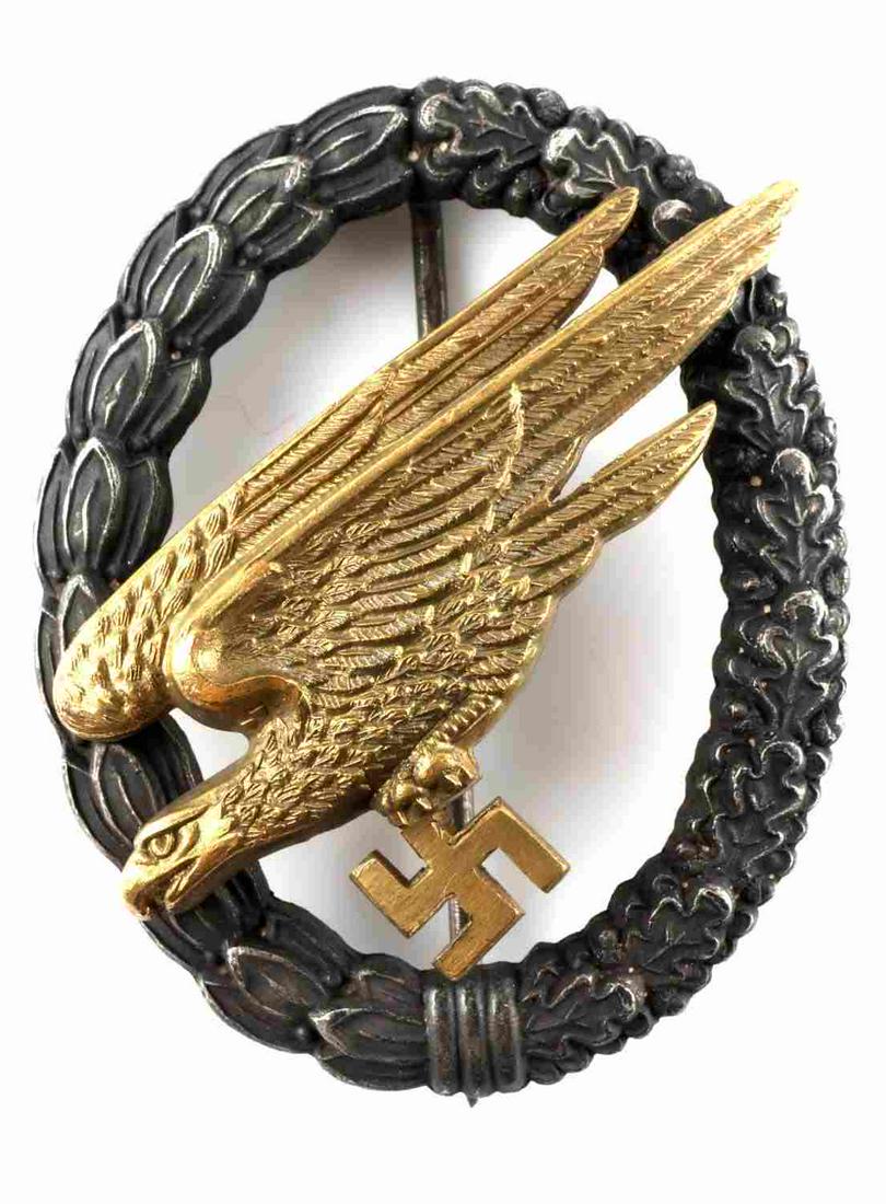 WWII GERMAN REICH LUFTWAFFE PARATROOPER BADGE: WWII German Third Reich Luftwaffe paratrooper badge measuring 2 1/4 X 1 7/8 inches. Reverse side features two high domed rivets and a vertical pin back, has an inscription that reads" C.E. JUNCKER BER