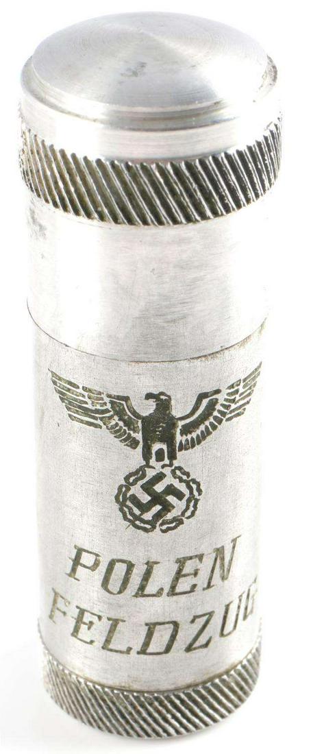 WWII THIRD REICH GERMAN TRENCH LIGHTER POLEN FELD: German trench lighter. Reichsadler on front with Polen Feldzug, swastika on bottom. Stands 2 1/8 inches tall.