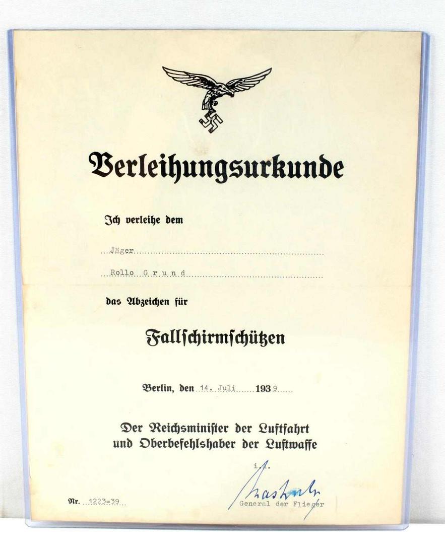 WWII THIRD REICH LUFTWAFFE PARATROOPER DOCUMENT: German WWII Luftwaffe Paratrooper Fallschirmjager Badge Document. Measures 8 1/2" wide by 11 1/16” tall. This document was awarded to ‘Jager Roloo Grund’ on ‘14. Juli 1939’. It is signed by 