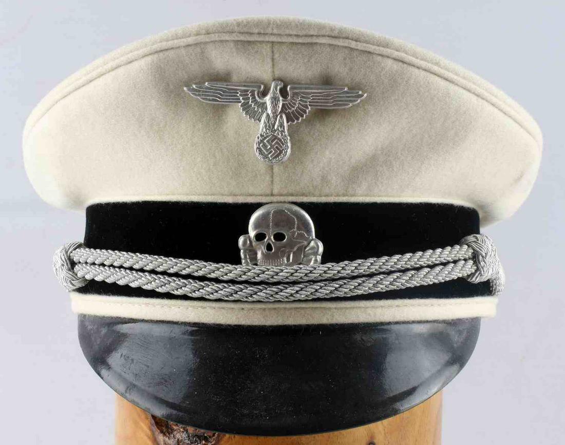 POST WWII THIRD REICH WAFFEN SS OFFICER VISOR: Post German WWII Waffen SS White Top Officers Visor Cap. The body is white wool with white wool piping. Has a metal nickel SS eagle and skull with cross bones mounted onto the front. Has a black leath