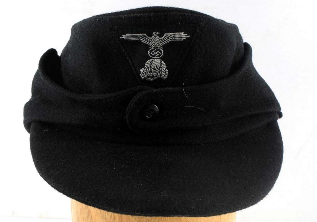 WWII GERMAN PANZER SS ENLISTED MANS M43 CAP: WWII German Panzer SS EM M-43 cap. Has one-piece bevo trapezoid Waffen SS eagle & skull machine sewn onto the front. Body is black wool. Inside gray cotton lining is marked ‘SS-BW’ (concentration 