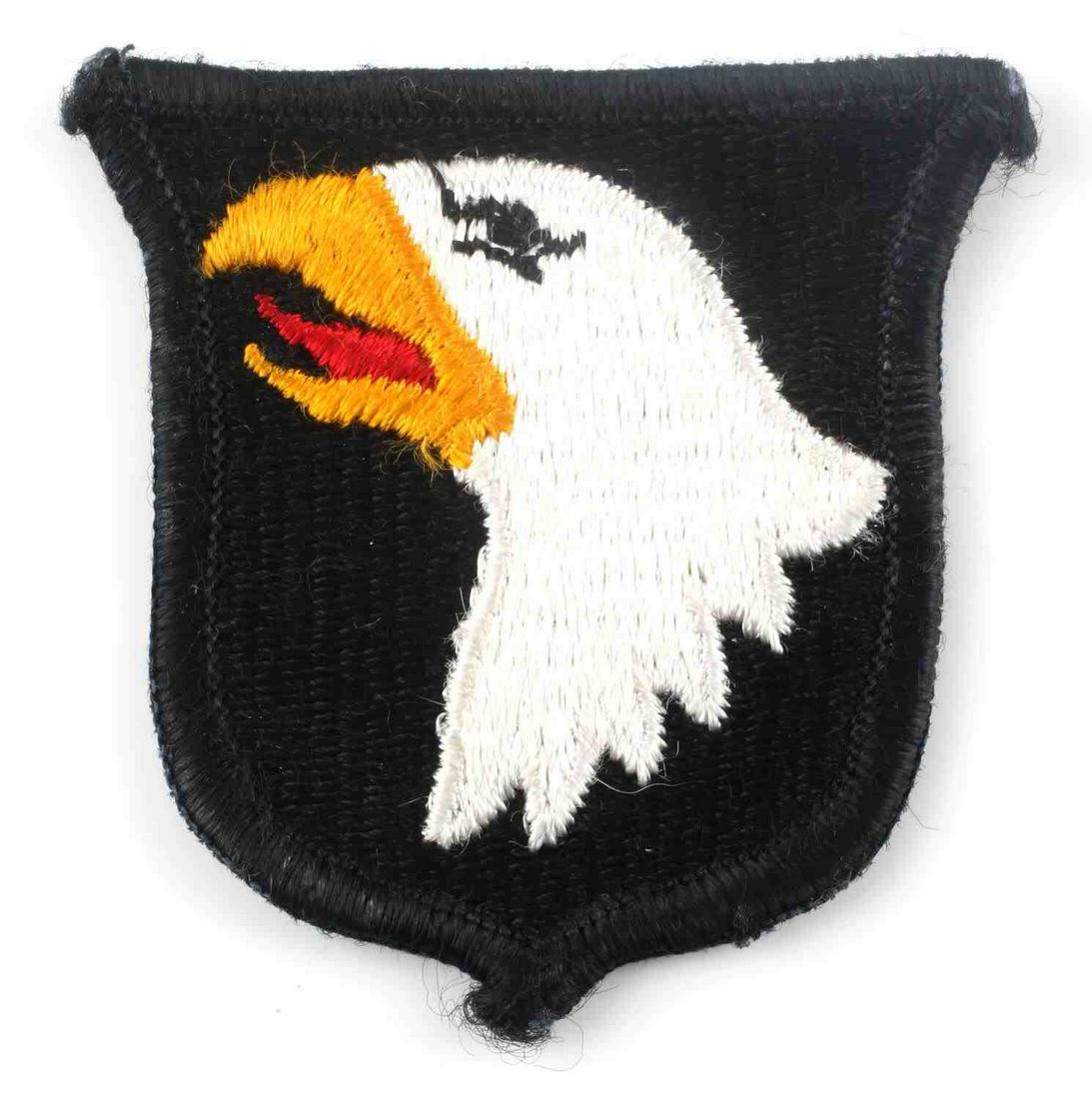 U.S. WWII ARMY 101ST AIRBORNE PARATROOPER PATCH: US WWII Army 101st Airborne Paratrooper Screaming Eagle Patch. Measures 2 3/8” wide by 2 3/8” tall. The front shows the profile of an eagle’s head with a red tongue. One piece machine embroidere