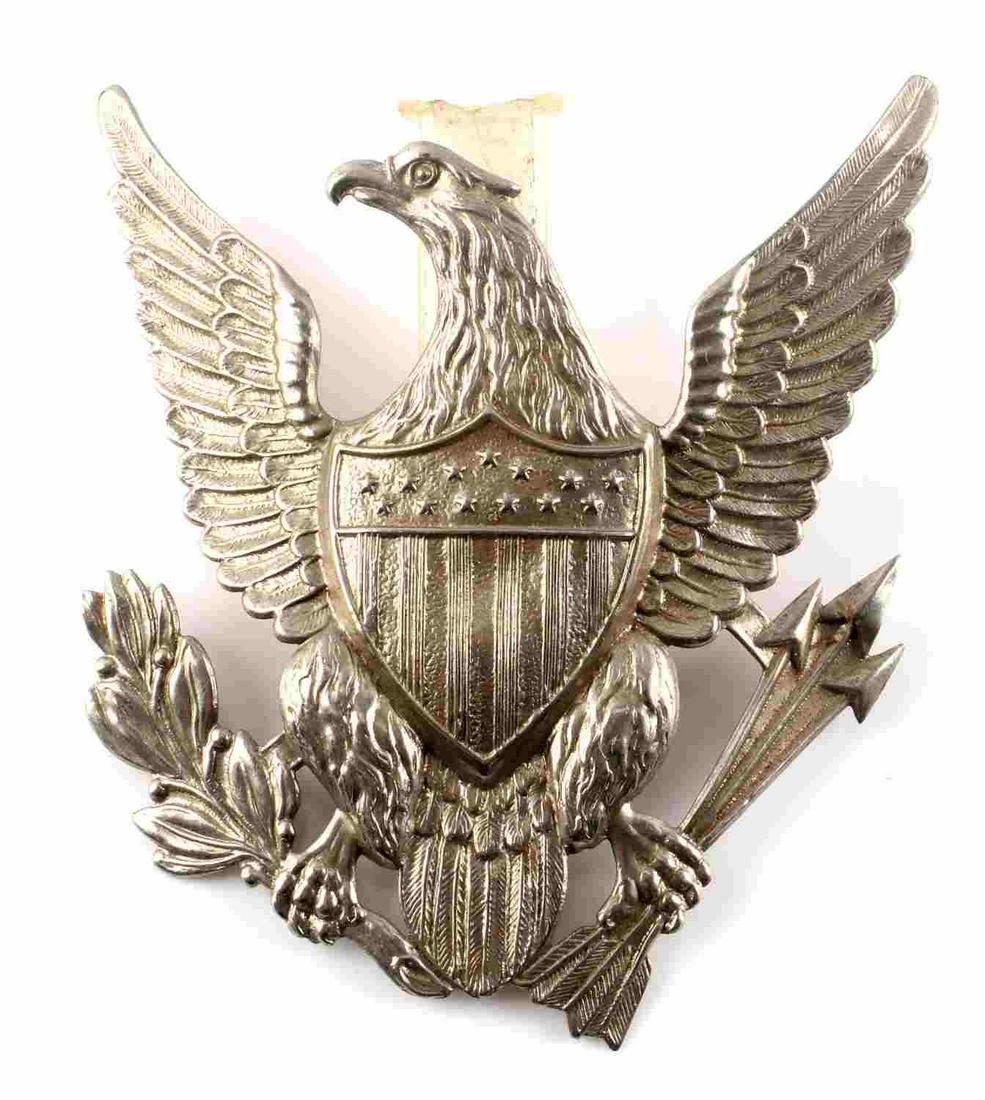 U.S. INDIAN WARS ARMY MILITARY SPIKE HELMET EAGLE: US Indian Wars Army 1880’s Military Spike Helmet Eagle Front Plate. Measures 4 1/8” wide by 4 1/4” tall. The front shows a spread winged eagle with a shield in the center of his chest. He is clu