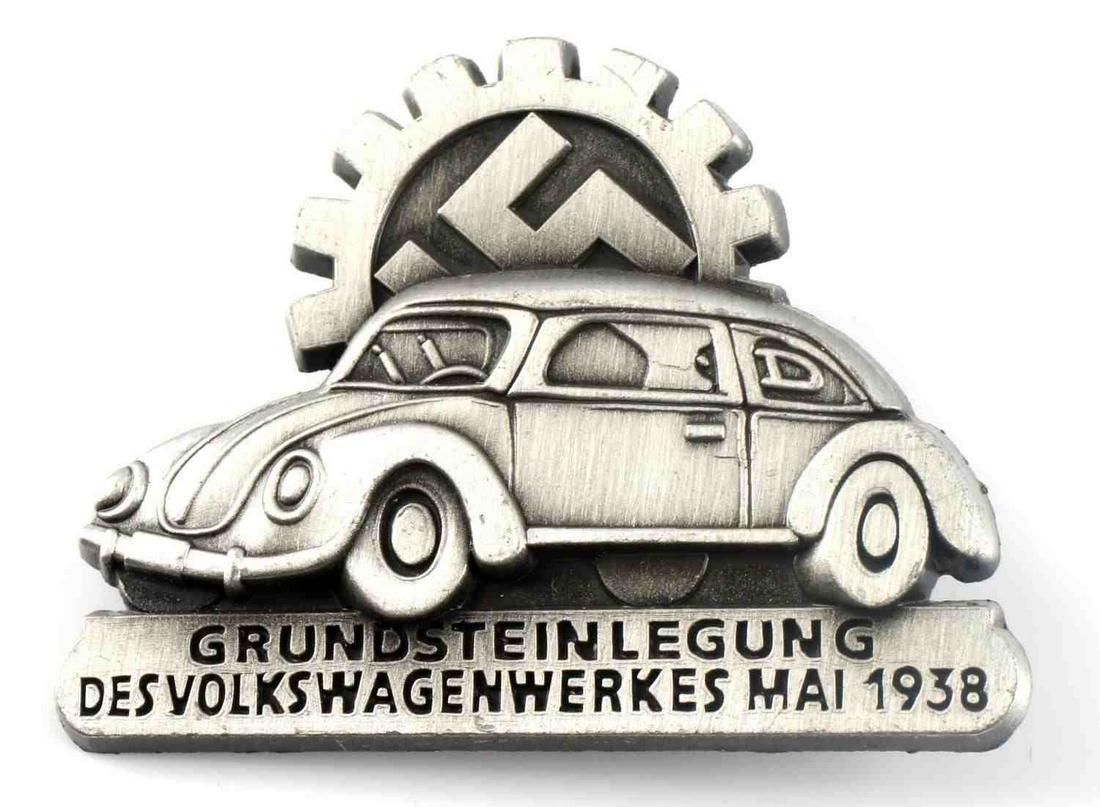 WWII GERMAN 1938 VW GROUND BREAKING PLANT BADGE: WWII German 1938 Volkswagen ground breaking plant badge. Obverse reads 'Grunsteinlegung Des Volkswagenwerks Mai 1938' with Volkswagen with swastika inside gear. Reverse marks 'ges gesch R. Schenkel Pf