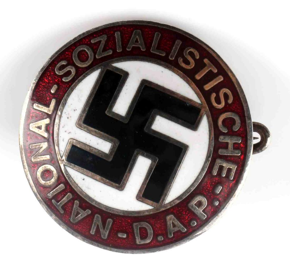 WWII GERMAN THIRD REICH NSDAP MEMBERSHIP BADGE: WWII German National Sozialistische DAP membership badge. Obverse reads 'NATIONAL SOZIALISTISCHE DAP' with swastika to center. Reverse marked 'RZM M1/129. Thin horizontal pin. Measures 25mm. Unauthent