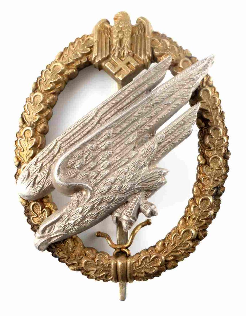 WWII THIRD REICH FALLSCHIRMJAGER JUMP BADGE: German WWII Army Paratrooper Fallschirmjager Jump Badge – Named. Measures 1 5/8” wide by 2 1/8” tall. The front shows a diving Luftwaffe eagle in the center with an Army eagle clutching a swasti